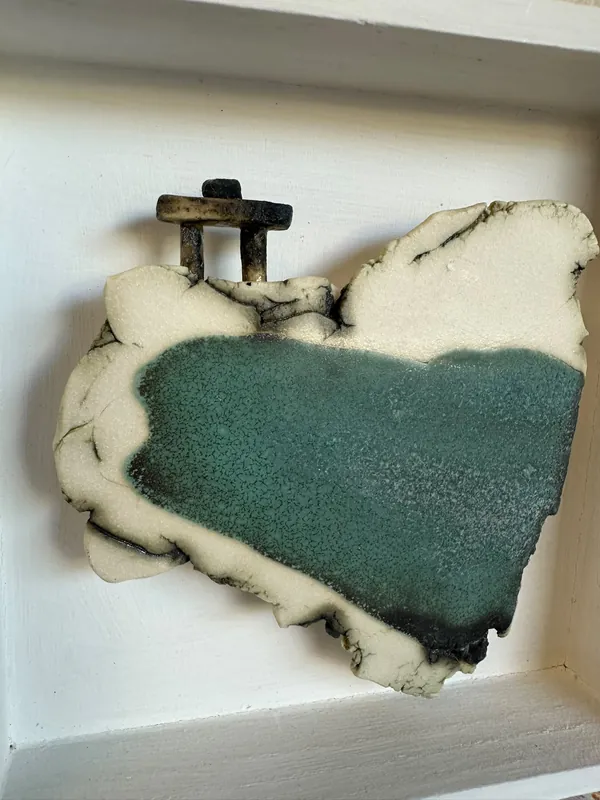 Turquoise and cream ceramic coastal scene in a white box frame
